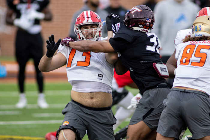 Feb 1, 2022; Mobile, AL, USA; American offensive lineman Max Mitchell of Louisiana (73) with American defensive lineman Amare Barno of Virginia Tech (38) during American practice for the 2022 Senior Bowl at Hancock Whitney Stadium. Mandatory Credit: Vasha Hunt-USA TODAY Sports